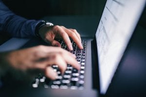 Person typing on computer keyboard