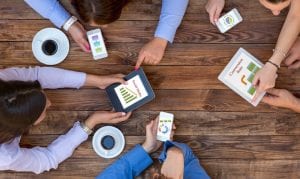 People on phones at a table