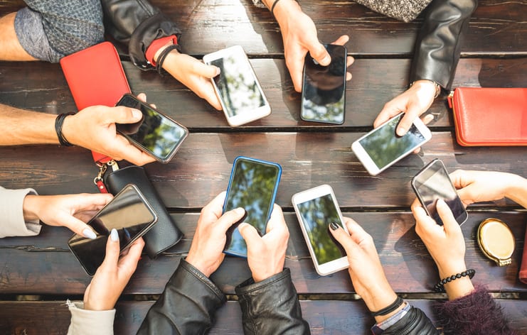 Social media influencers at work on their cell phones