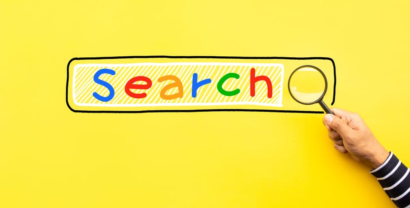 A magnifying glass examines the google search engine bar.